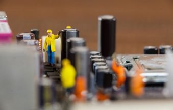 miniature-workers-working-chip-motherboard